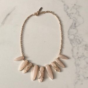Gold color necklace with rose quartz stones.